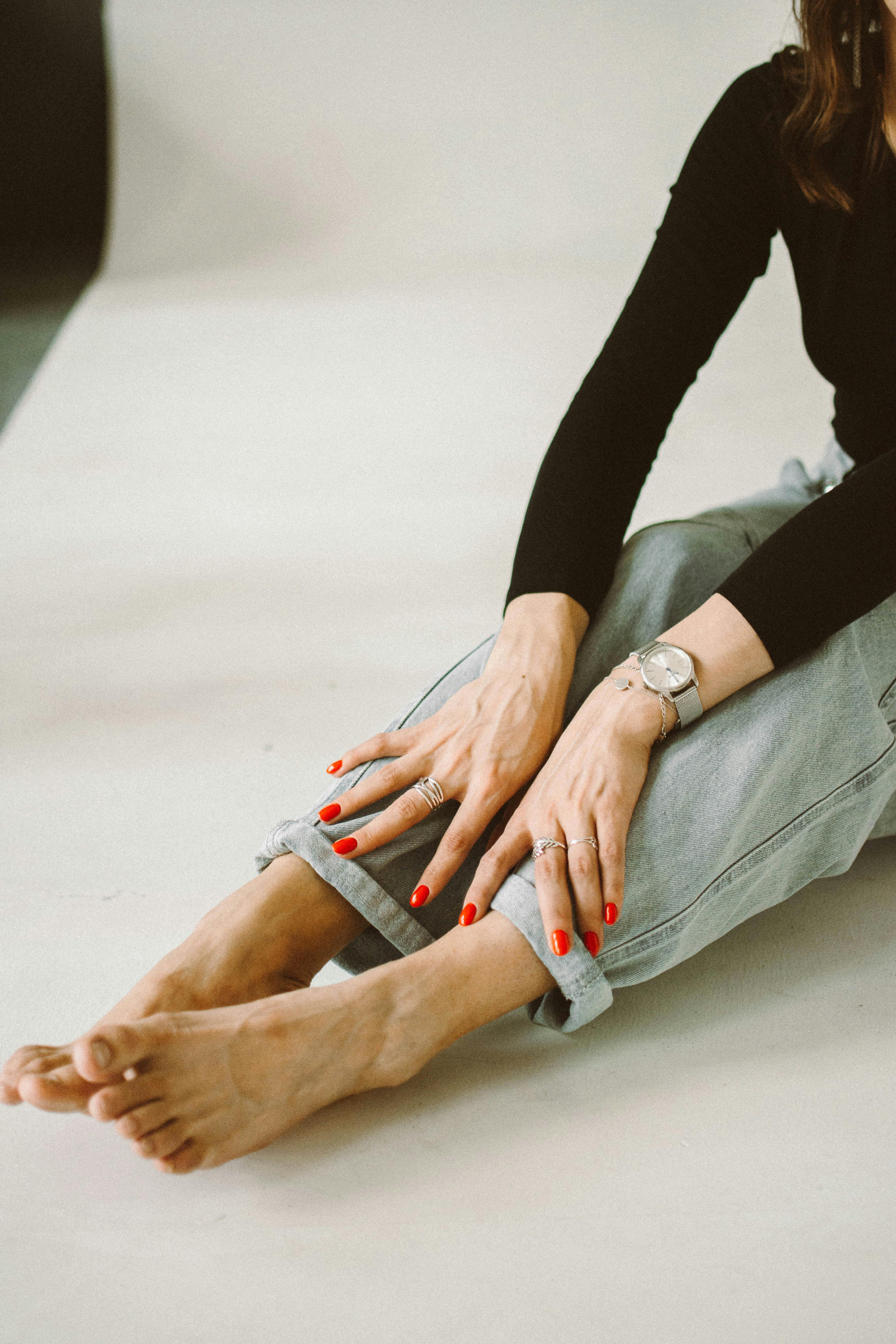 Low Section Of Barefoot Woman Sitting On Floor · Free Stock Photo