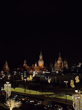 Illuminated night scene of the Red Square with vibrant city lights and festive decorations.