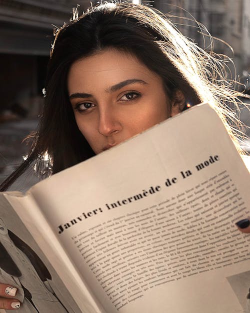 Close-Up Shot of a Pretty Woman Holding a Book