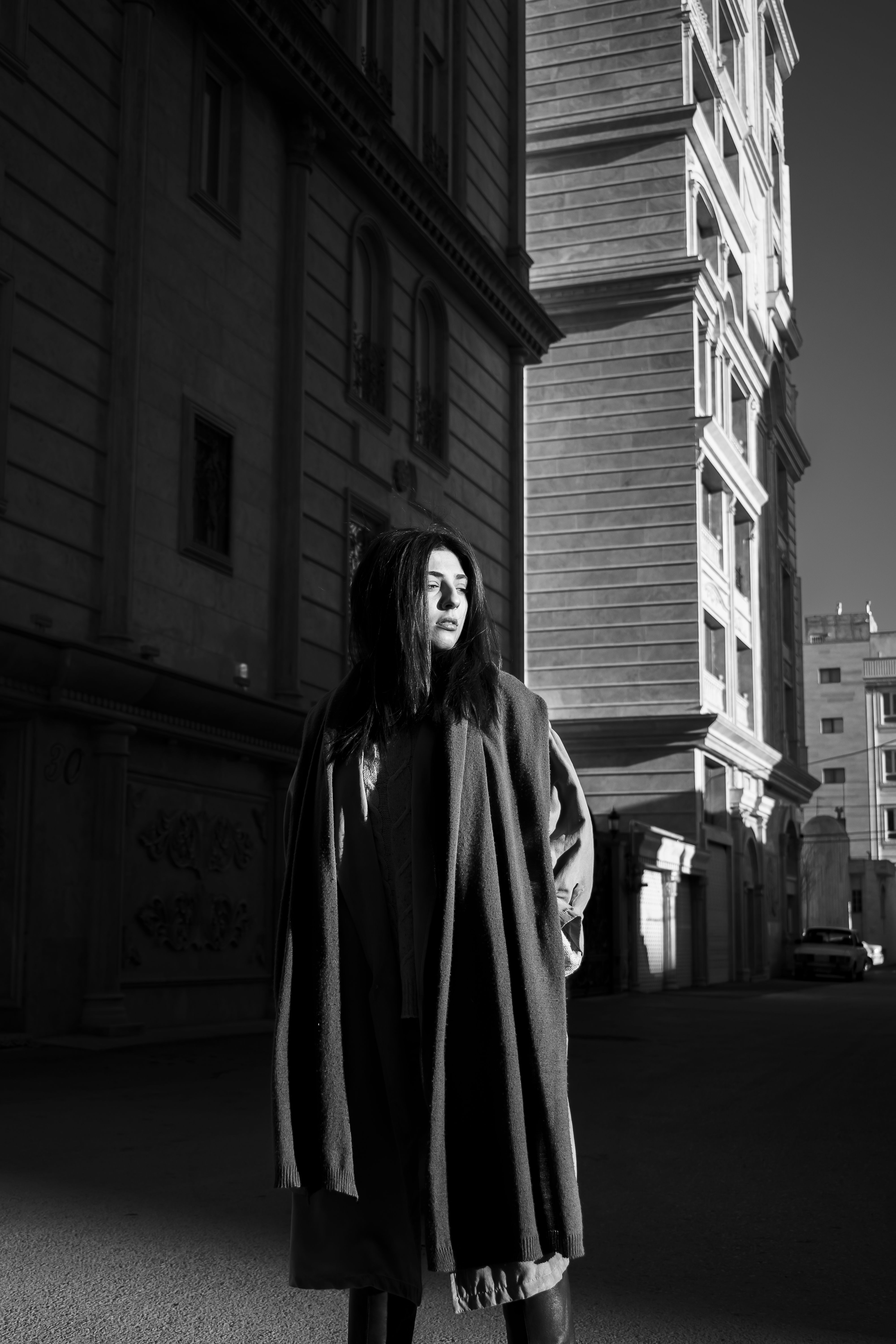 Grayscale Photo of a Woman Wearing a Coat Standing on the Road · Free ...