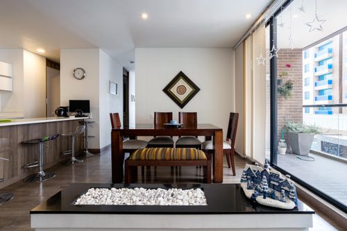 Free Stylish dining room in Bogotá with balcony view and contemporary decor. Stock Photo