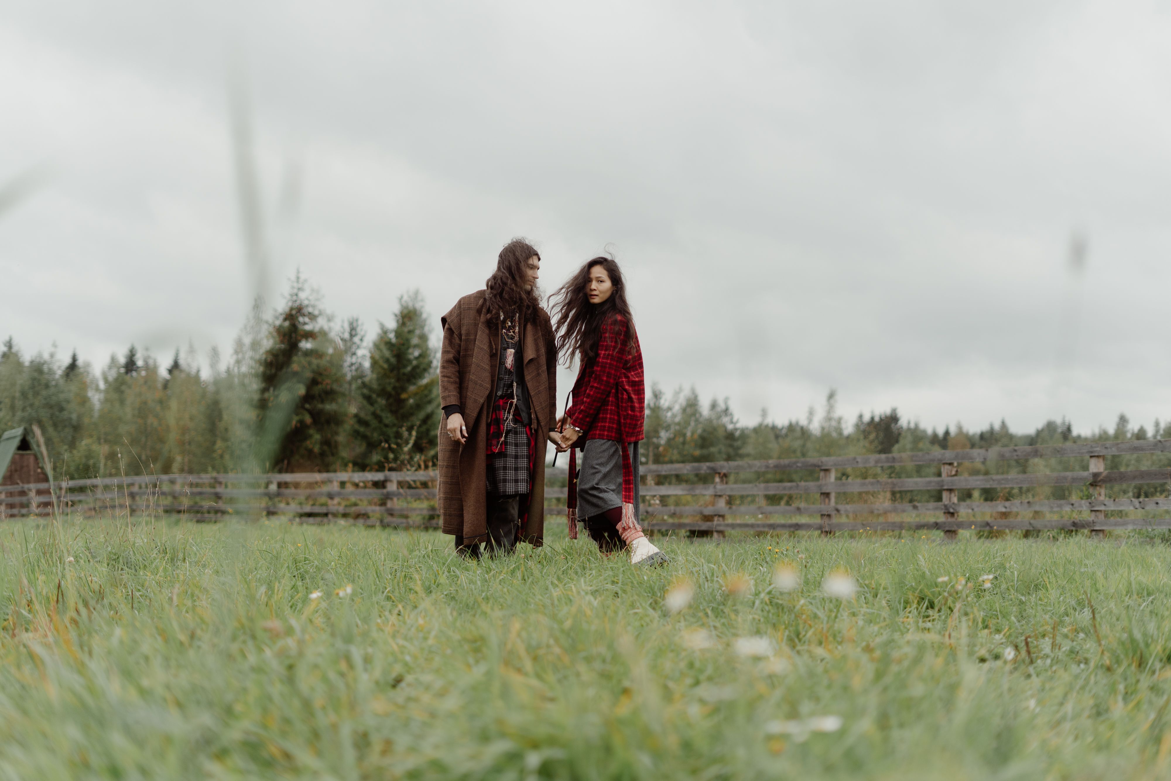 Couple Holding Hands While Standing on Green Grass Field · Free Stock Photo