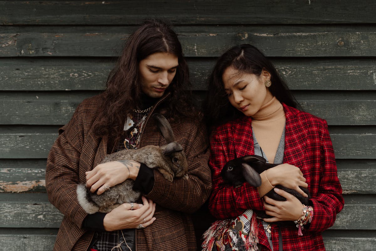 Man and Woman Holding Rabbits 