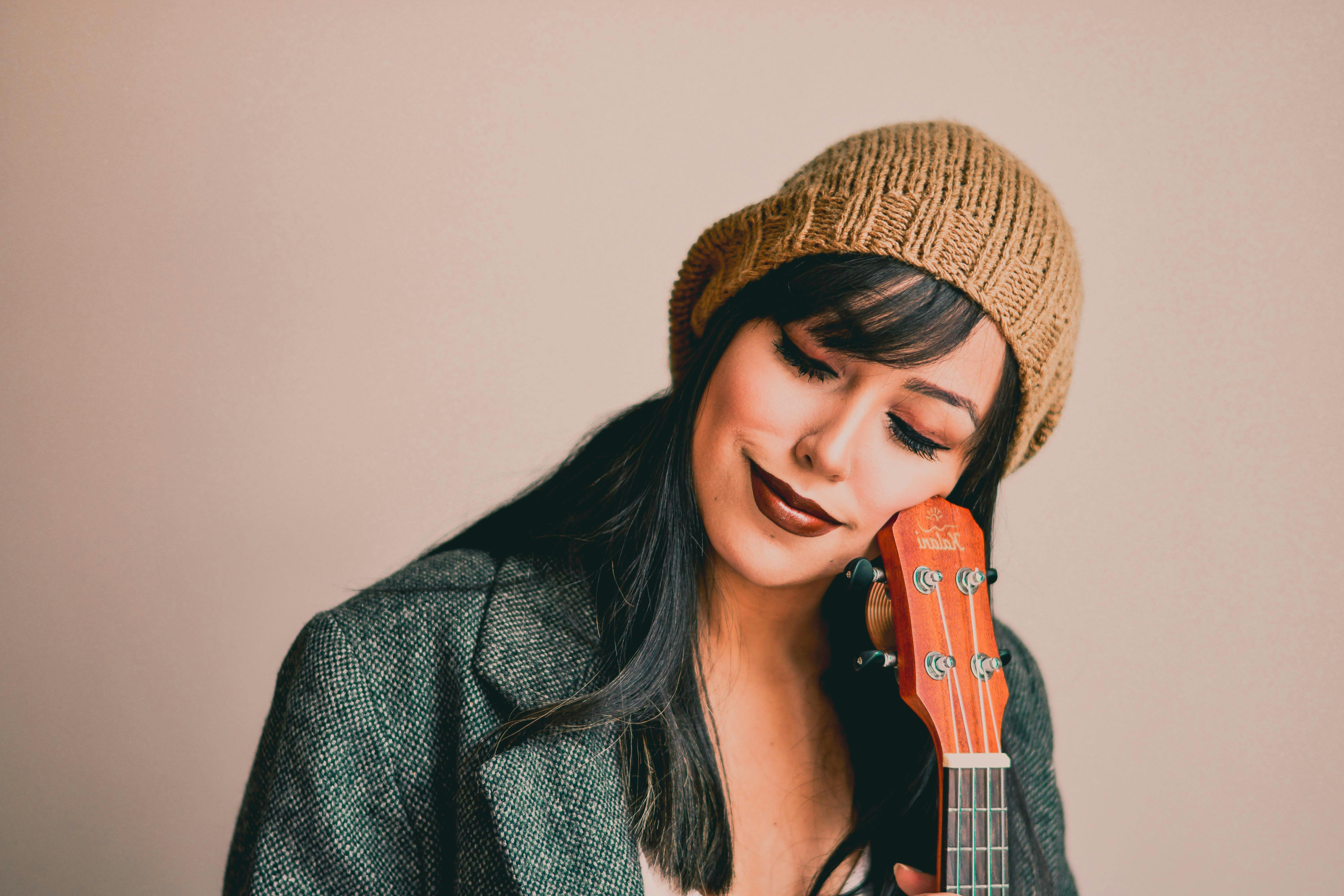 Photography of a Woman Holding Ukelele