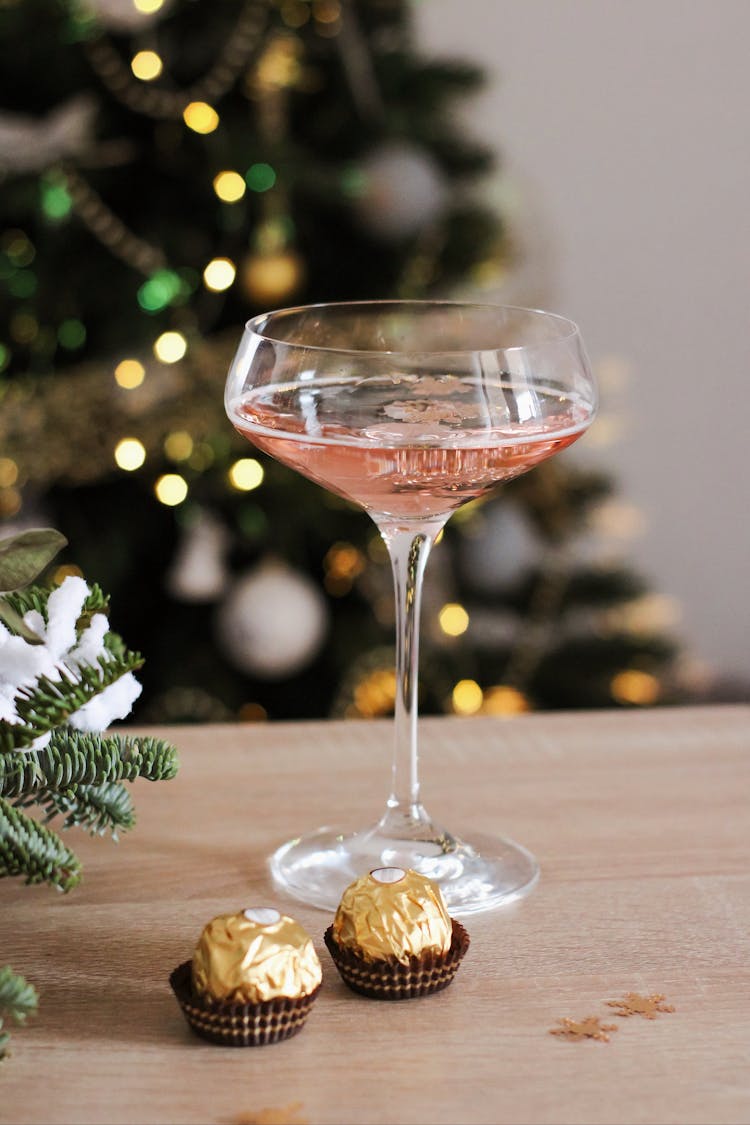 A Champagne Saucer Beside Chocolates