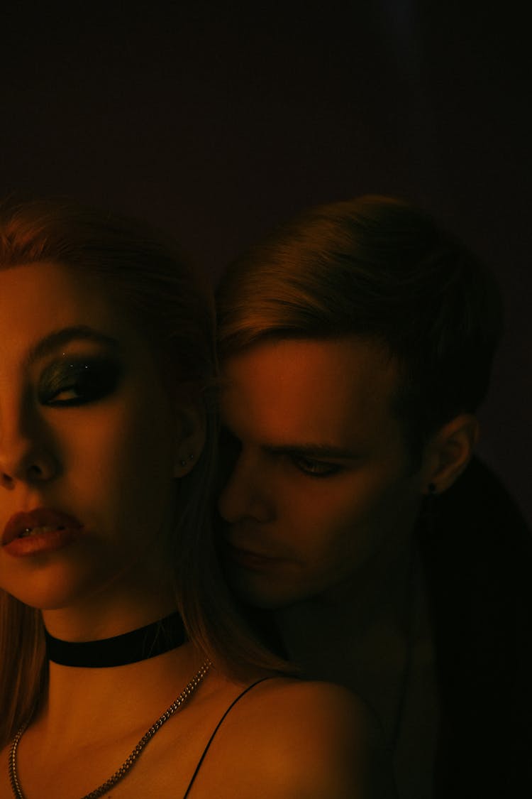 Couple With Black Makeup Posing In Dark