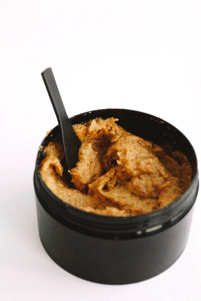 Brown exfoliating scrub with a spoon