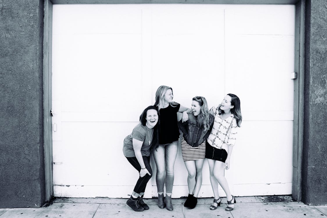 Free Grayscale Photography of Four Women Wearing Clothes Stock Photo