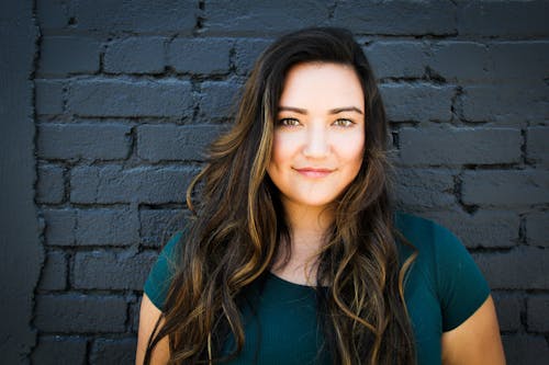 Free Close-Up Photography of a Woman Near Wall Stock Photo