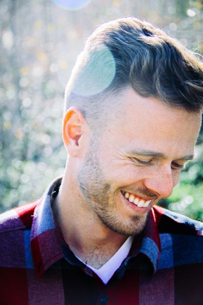 Smiling young man outdoors with bokeh background