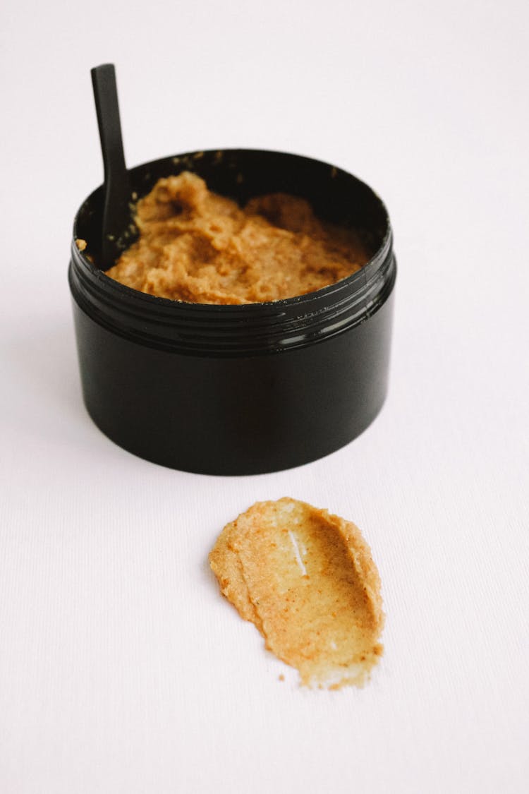 Brown Body Scrub In Black Plastic Jar 