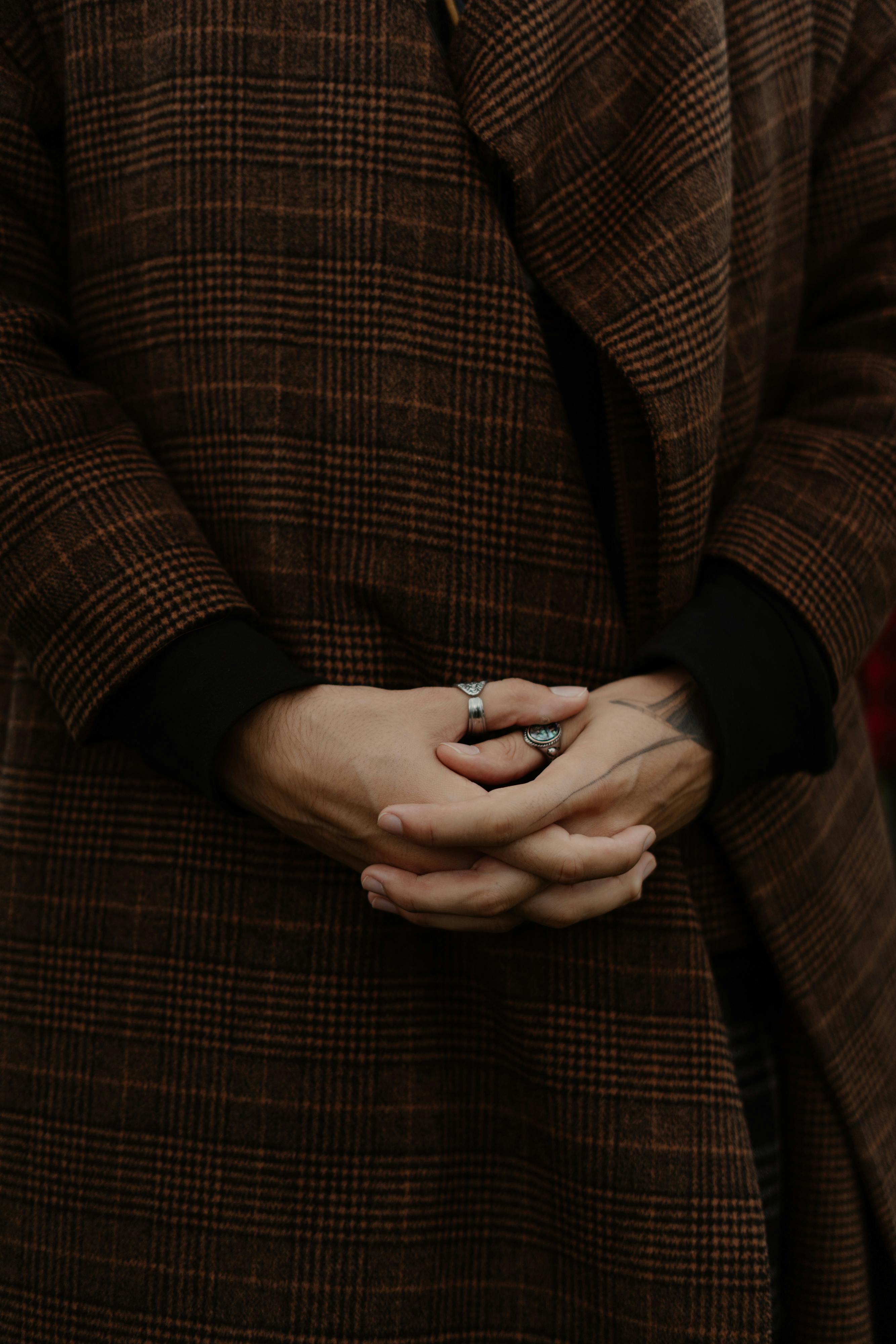 A Close-Up Shot of the Hands of a Person in a Coat · Free Stock Photo