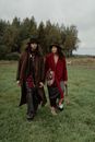 man and Woman walking on Grass Field