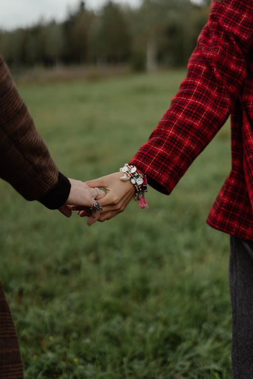 Couple Holding Hands on a Field 