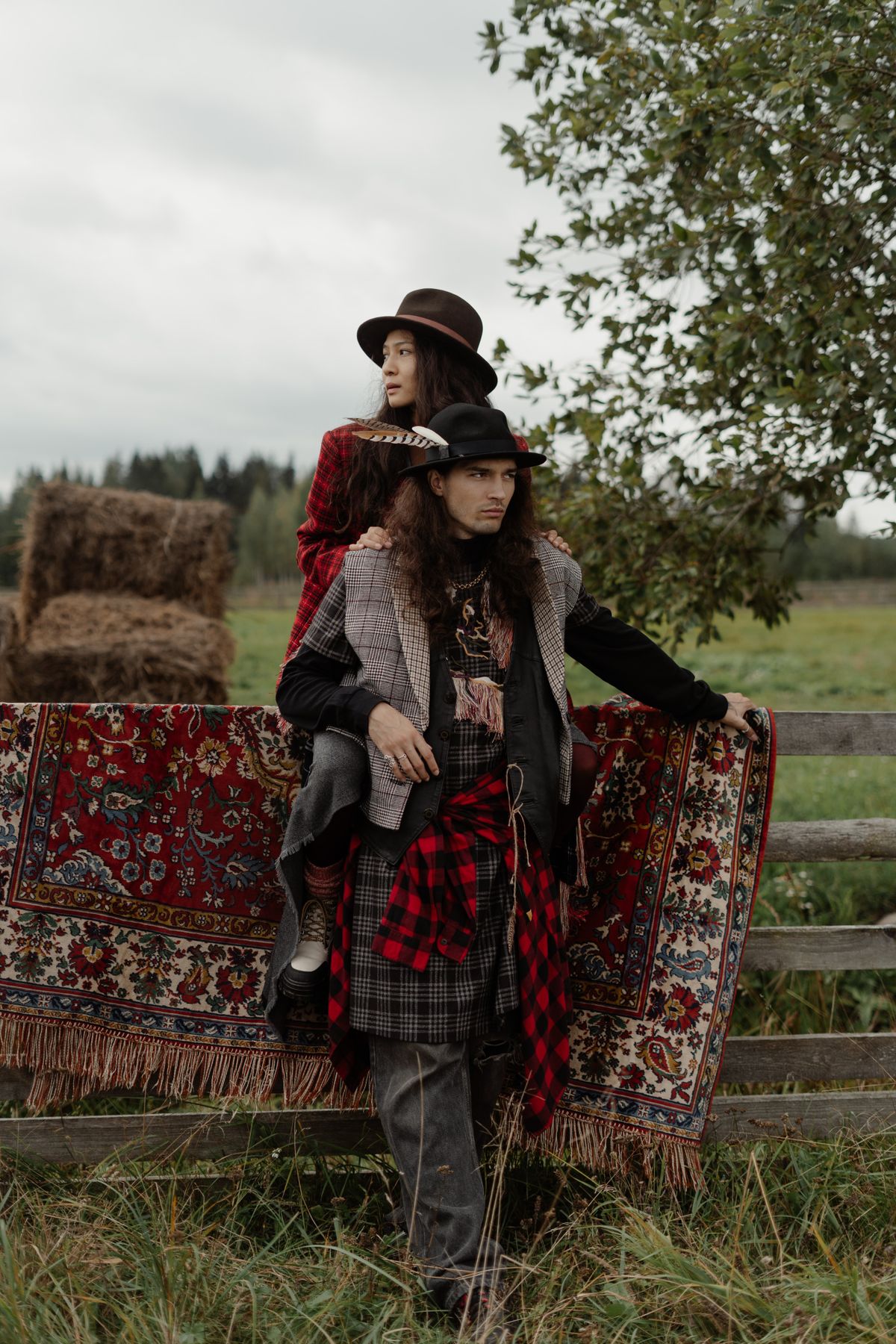 Couple in bohemian attire posing outdoors