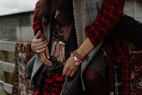 Couple Wearing Bohemian Clothes on a Field 