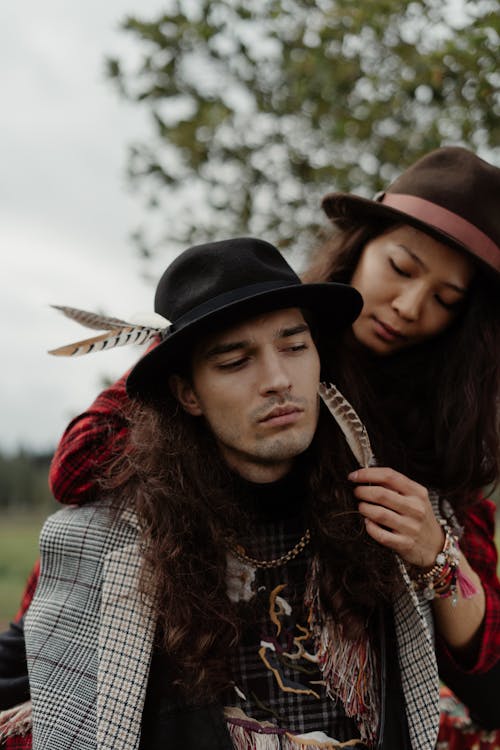 Couple Wearing Bohemian Clothes on a Field 