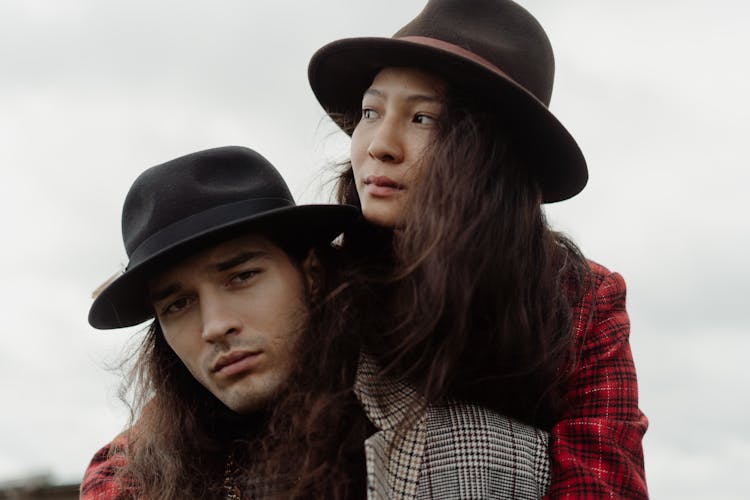 Couple Wearing Bohemian Clothes On A Field 