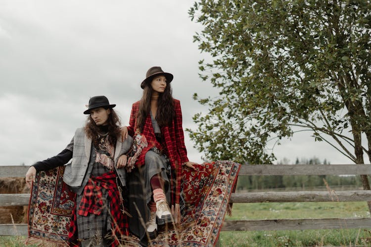 Couple Wearing Bohemian Clothes On A Field 