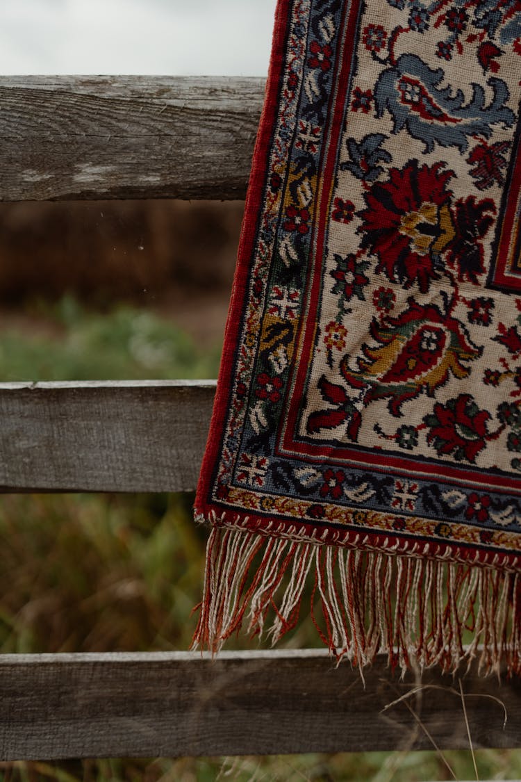 Ethnic Carpet Hanging On Wooden Fence