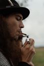 Man Lighting Cigarette with Zippo Lighter