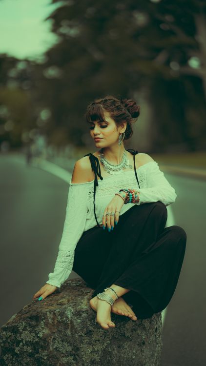 Woman in White Long Sleeves Sitting on Rock · Free Stock Photo
