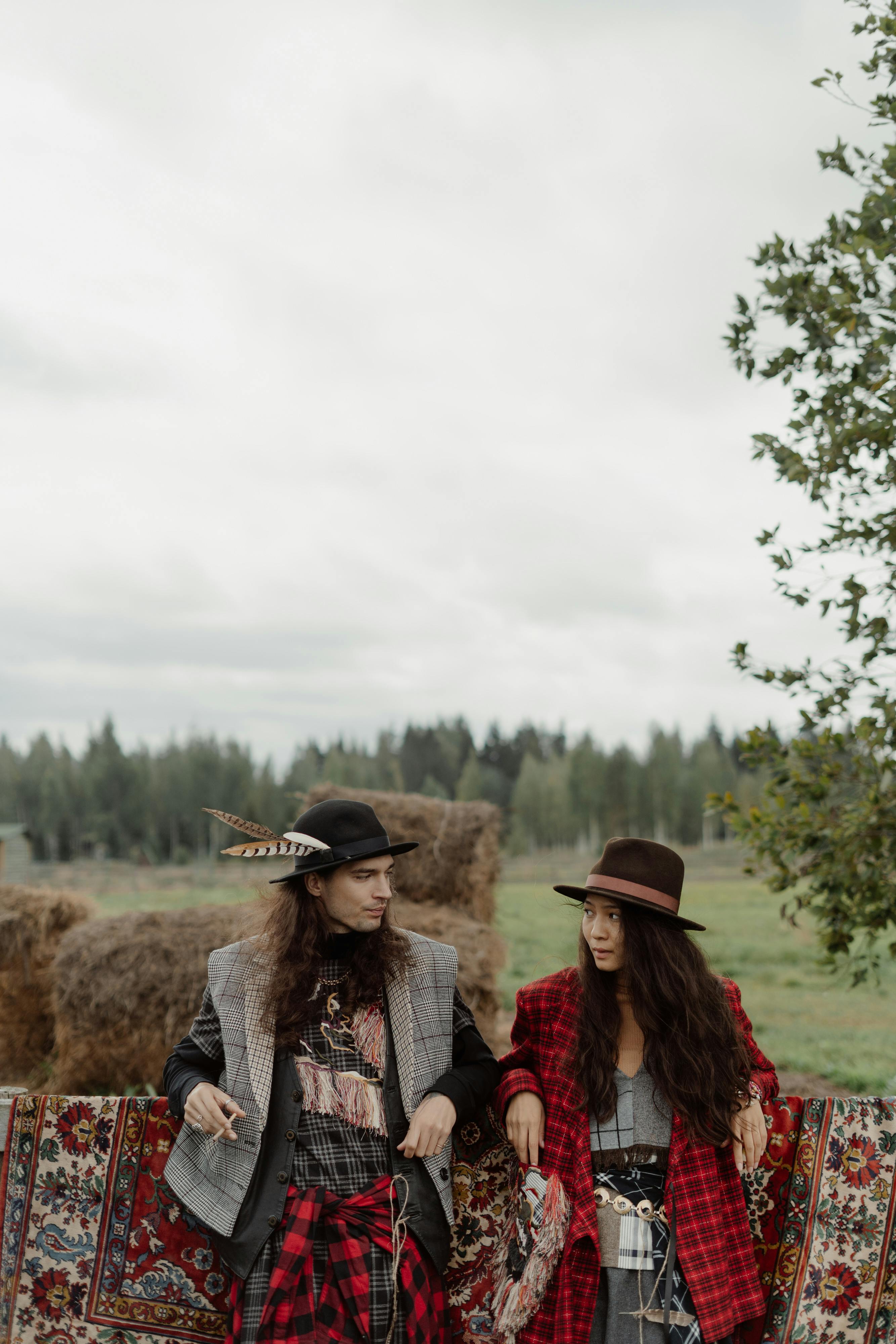 Women Posing on a Grass Field Under White Clouds · Free Stock Photo