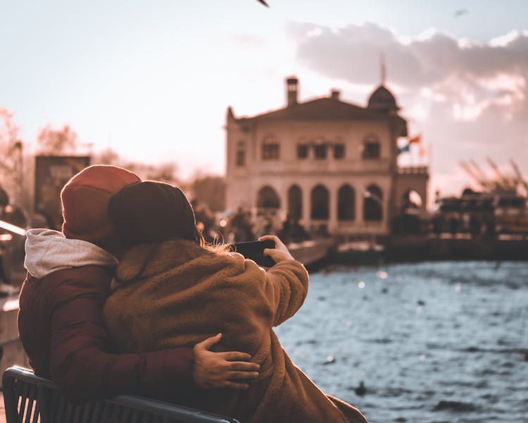 Man And Woman Photographing Building Together