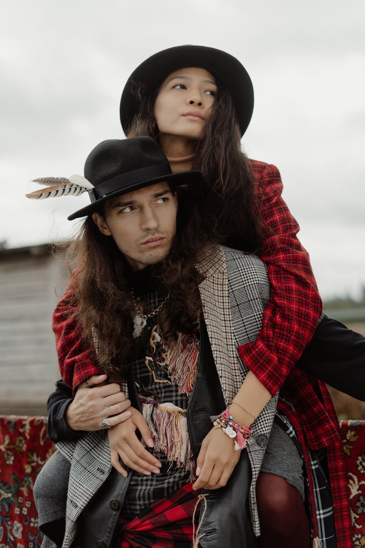 A Man And Woman In Checkered Coats