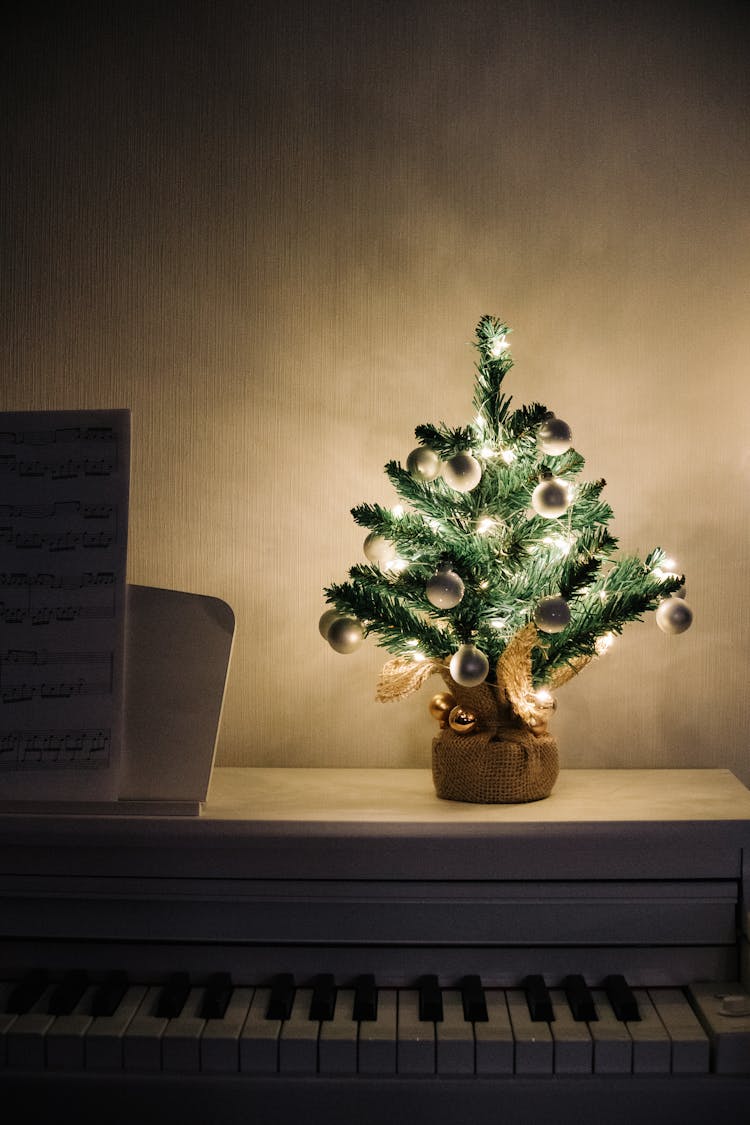 A Mini Christmas Tree On A Piano 