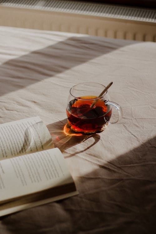 Book and Tea on Bed
