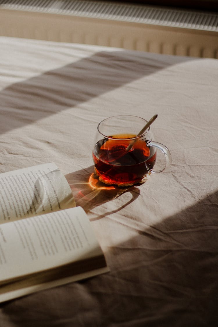 Book And Tea On Bed