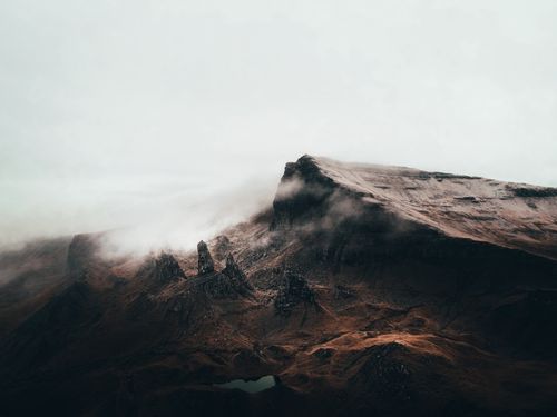Free Majestic rocky mountain shrouded in mist, capturing the mysterious atmosphere of rugged terrain. Stock Photo
