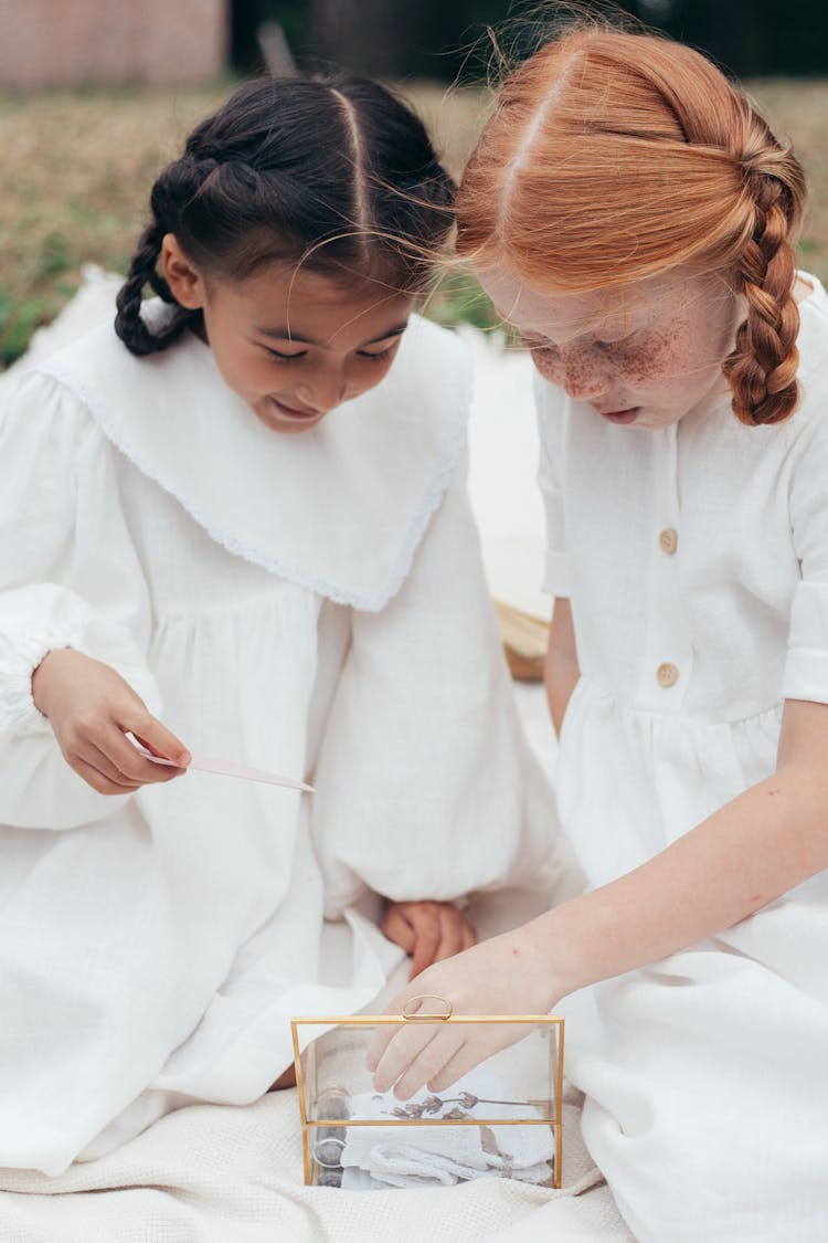 Girls In White Dresses Opening A Box 