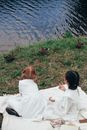 Children Sitting on a Picnic Blanket
