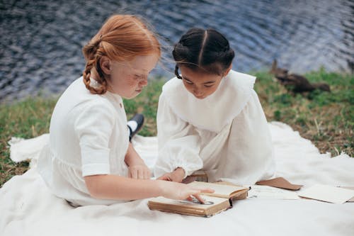 Free Girls in White Dress Reading a Book Stock Photo