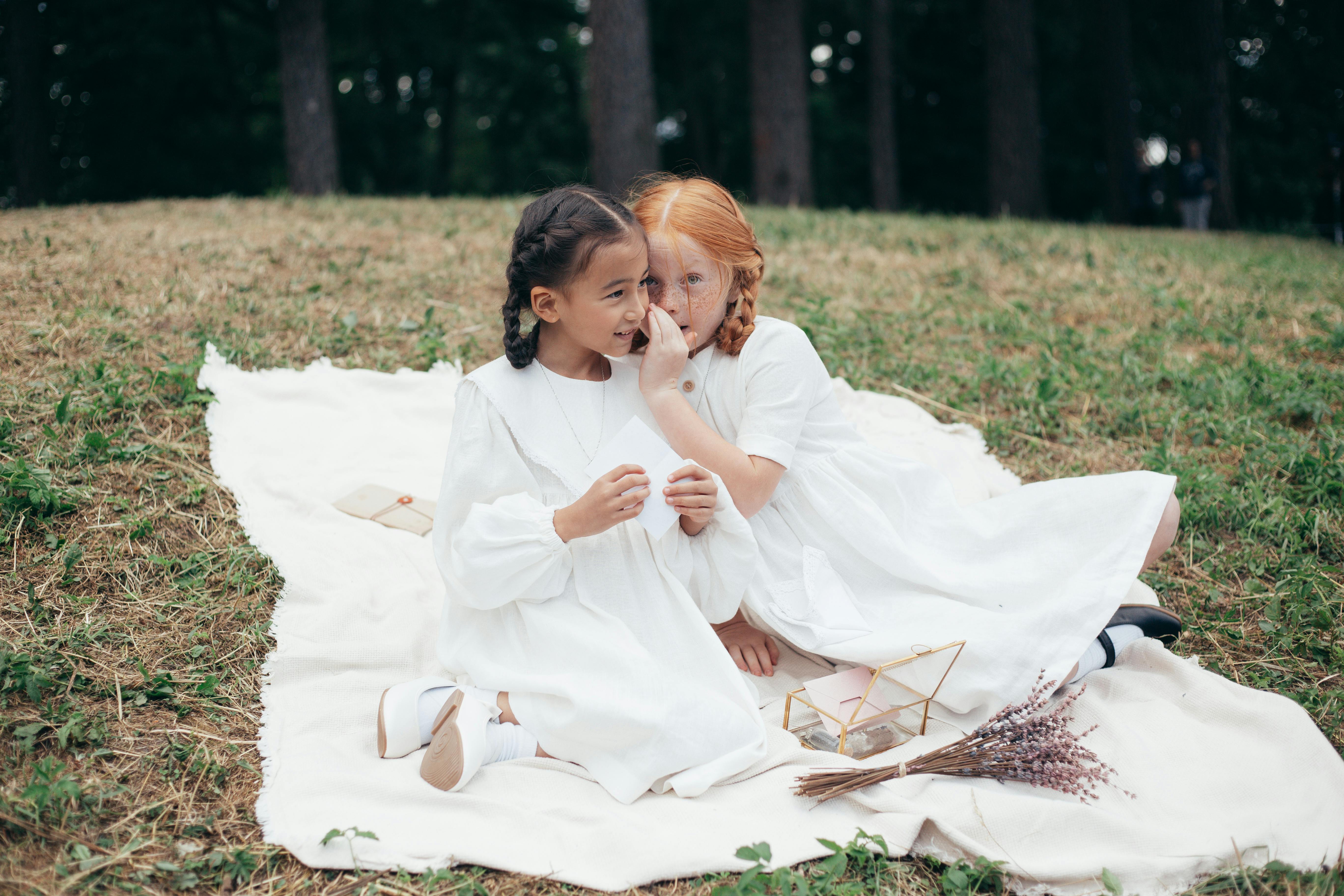 Free Girl Whispering Something to Her Friends Ear Stock Photo