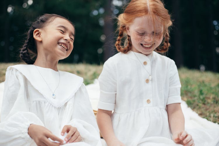 Two Happy Girls In White Dresses