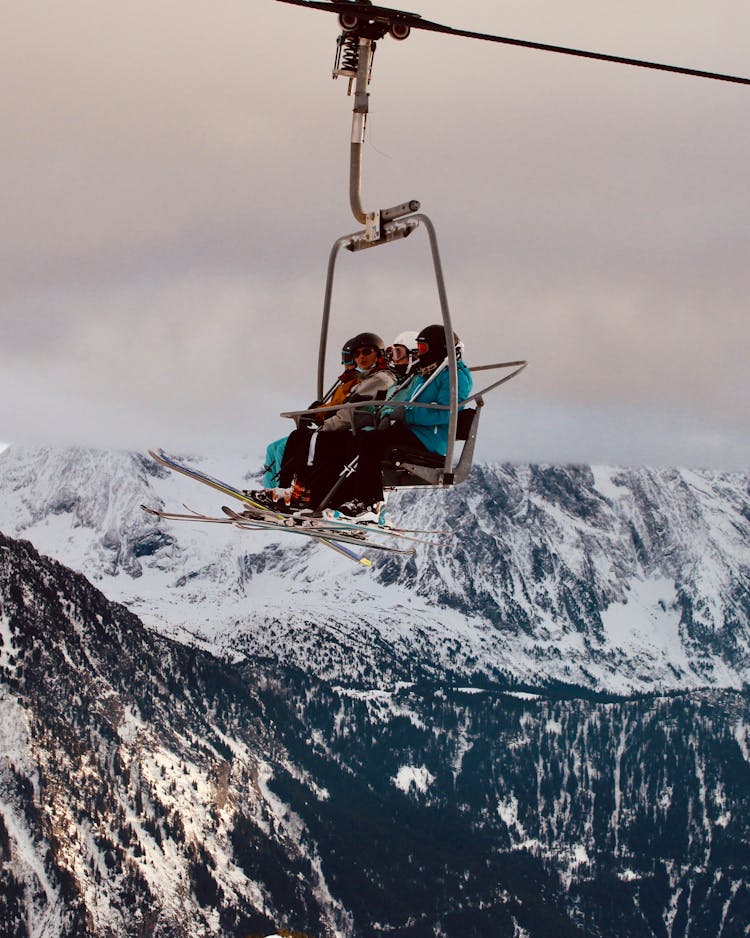 People In Ski Lift In Mountains