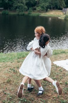 Girl in White Dress Standing on Green Grass Field Near Body of Water