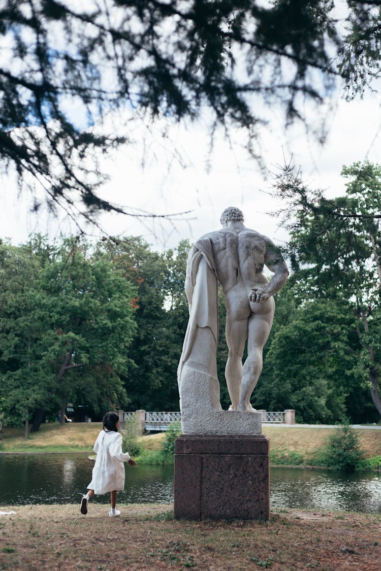 Girl In White Dress Playing In A Park