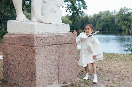 Girl Hiding Behind Statue