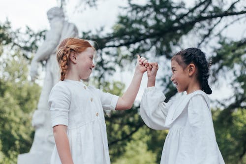 Free Two Young Friends Doing Pinky Promise Stock Photo