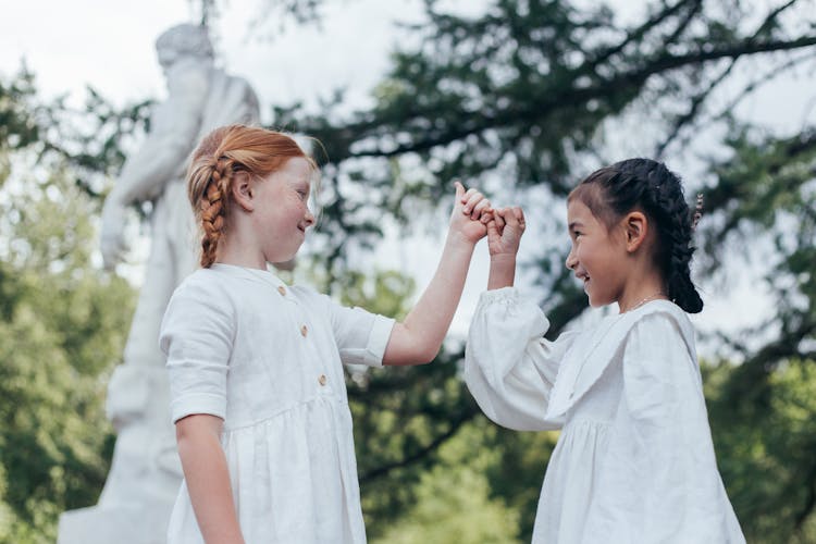 Two Young Friends Doing Pinky Promise