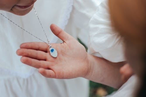 Free Girl Looking at Necklace of Friend Stock Photo