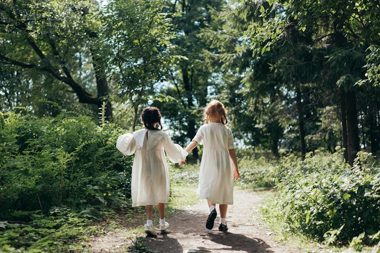 Two Girls Walking In The Forest