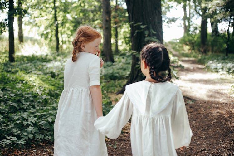 Two Girls Walking In The Forest