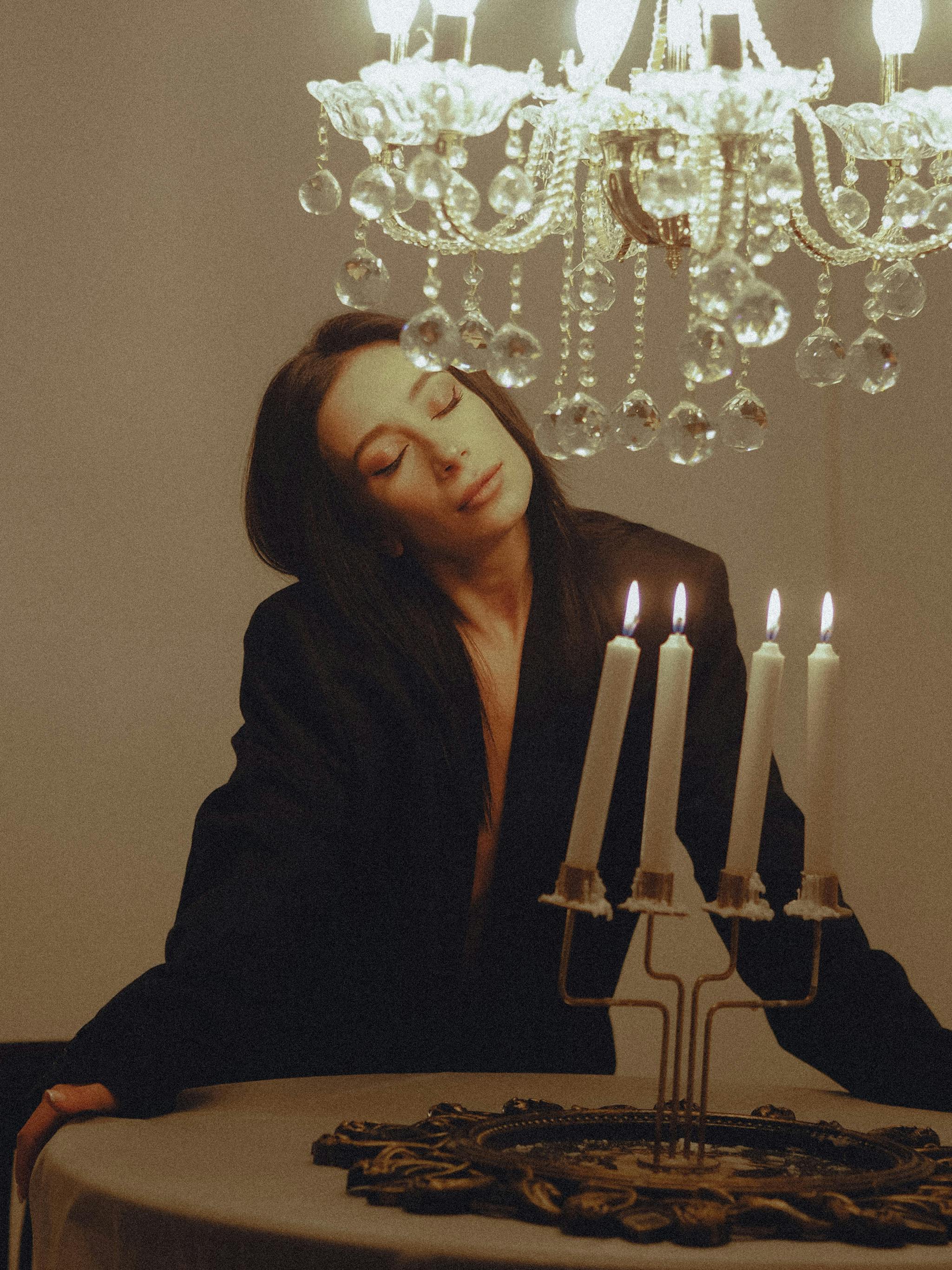 Woman with Closed Eyes at Table with Candles · Free Stock Photo