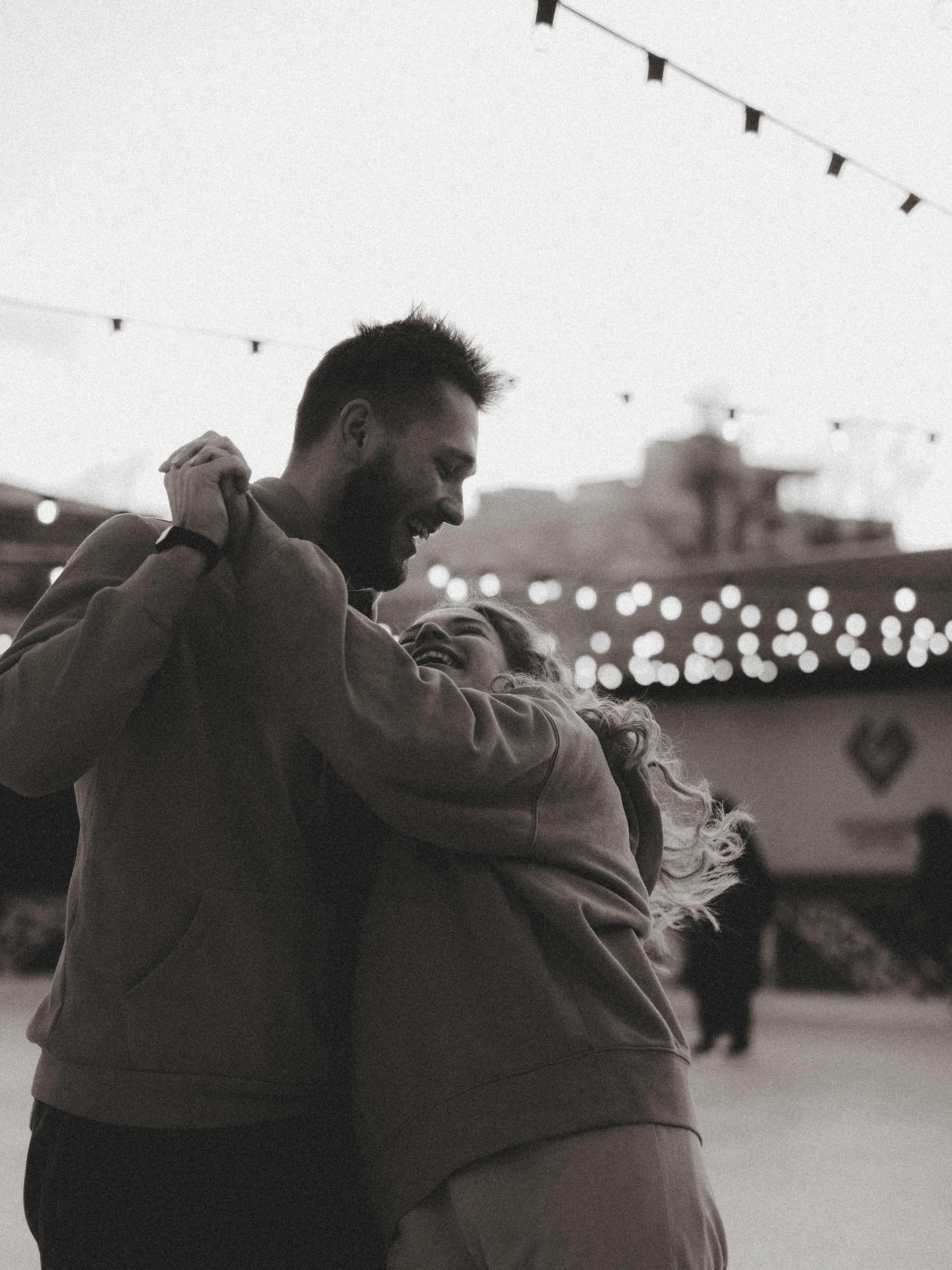 Smiling Couple Dancing Outdoors, Black and White · Free Stock Photo