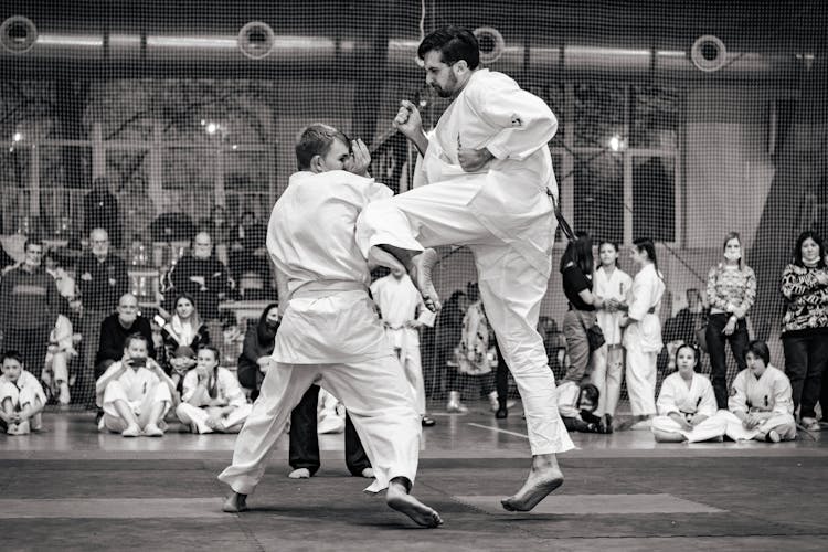 Grayscale Photo Of Man In White Karate Gi